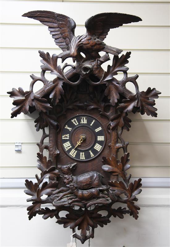 A Black Forest carved cuckoo clock 35in.